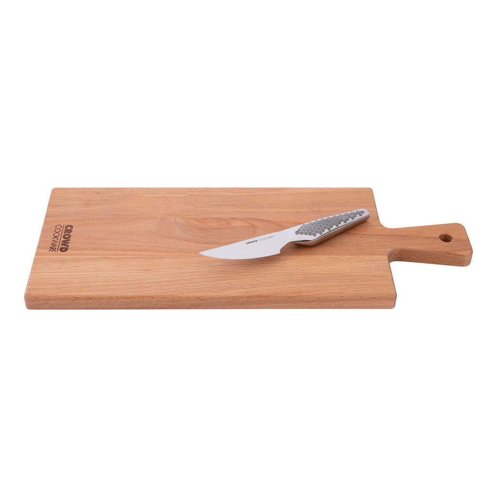 Rectangular cutting board 50x20 cm with handle made of beech wood with crowd cookware logo with paring knife side view lifesstyle image